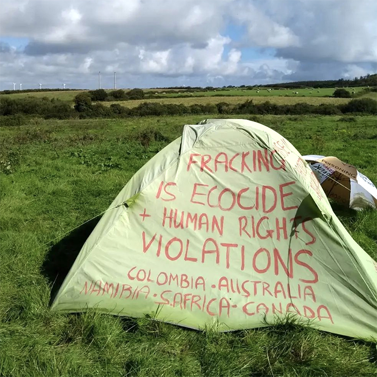 Tent covered in anti-fracking information in field near Shannon LNG proposed site in 2022