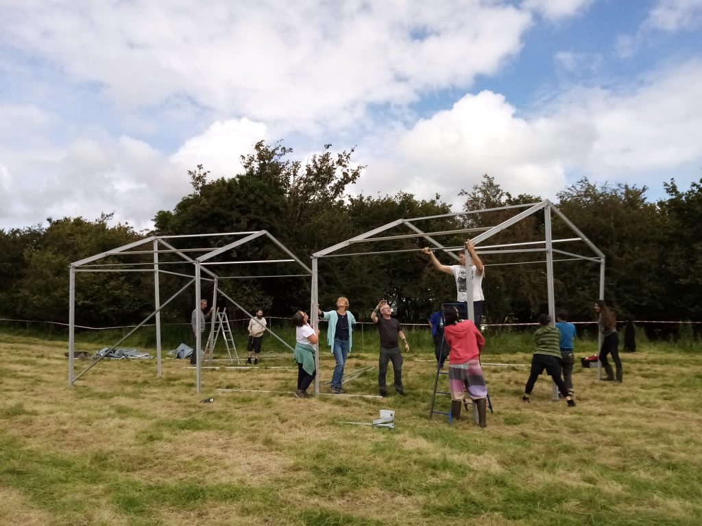 People working together to build marquees at Climate Camp Ireland 2023