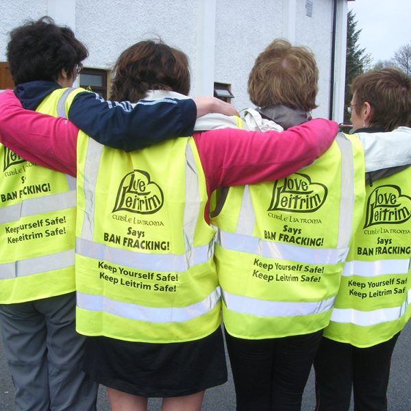 Love Leitrim activists in visi-vests linking arms in solidarity against fracking